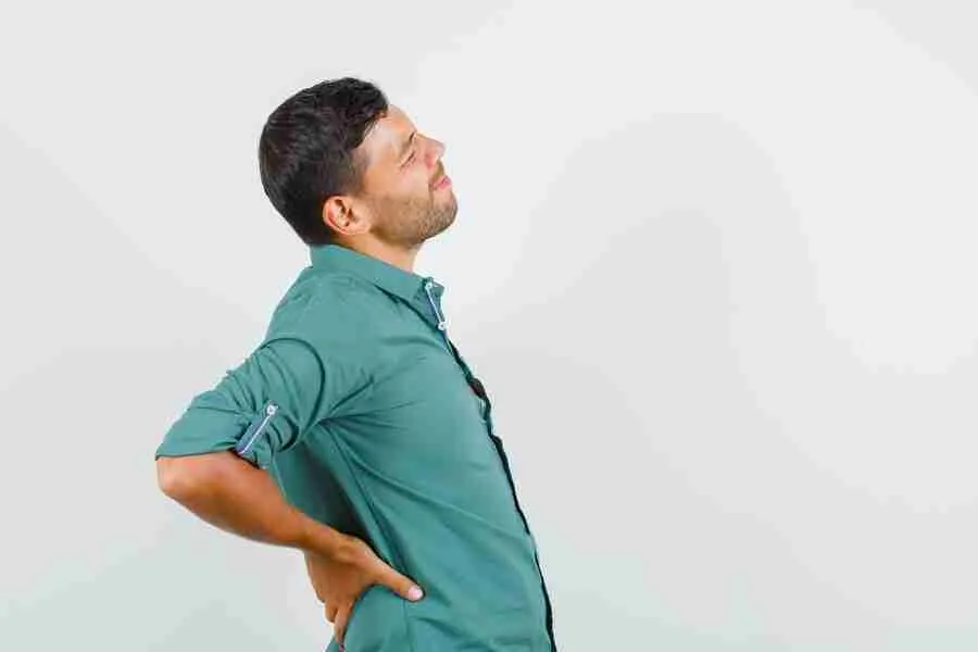 young man suffering from back pain shirt